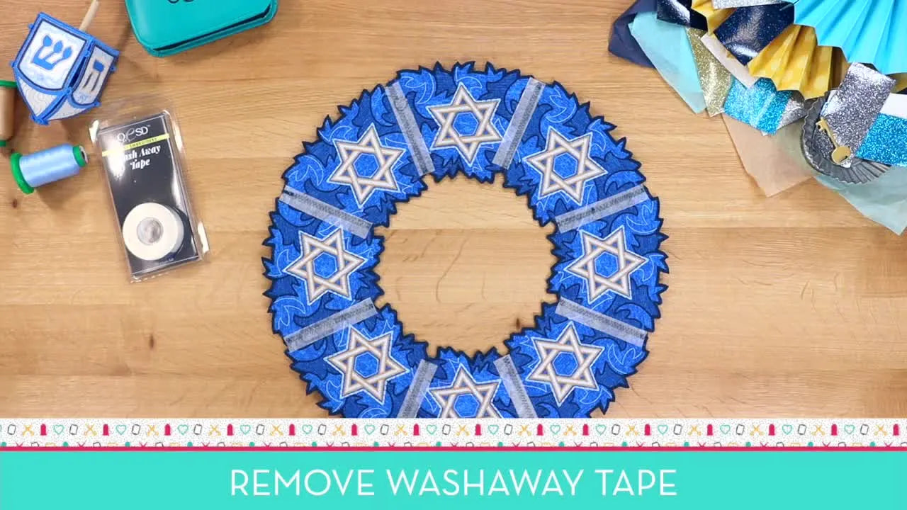 A completed freestanding Hanukkah wreath with Star of David details lies flat on a wooden surface, showing crisp wedge edges and clean assembly seams.