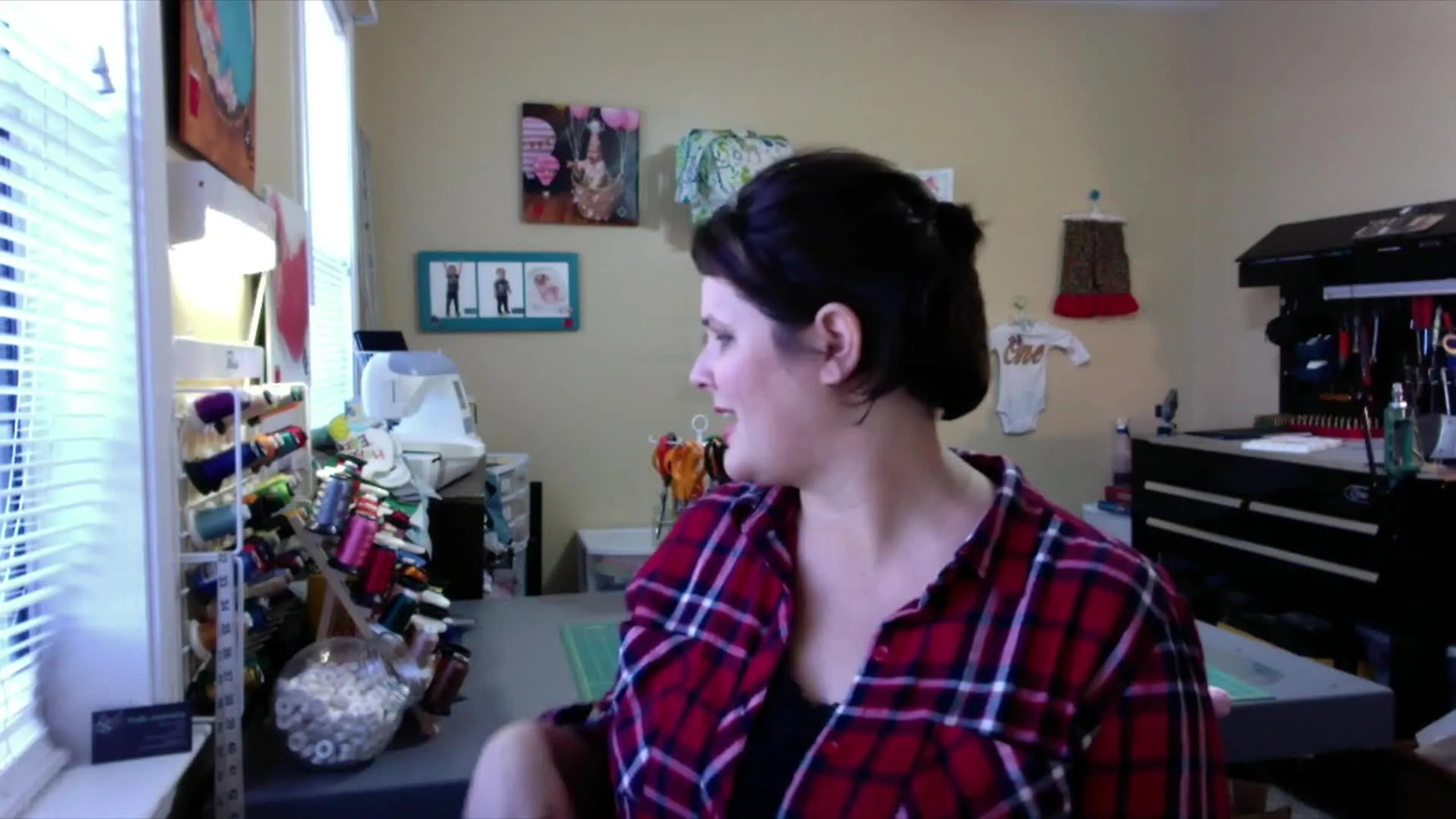 A close-up of a pink Floriani embroidery thread cone held to the camera, emphasizing the right thread choice for machine embroidery.