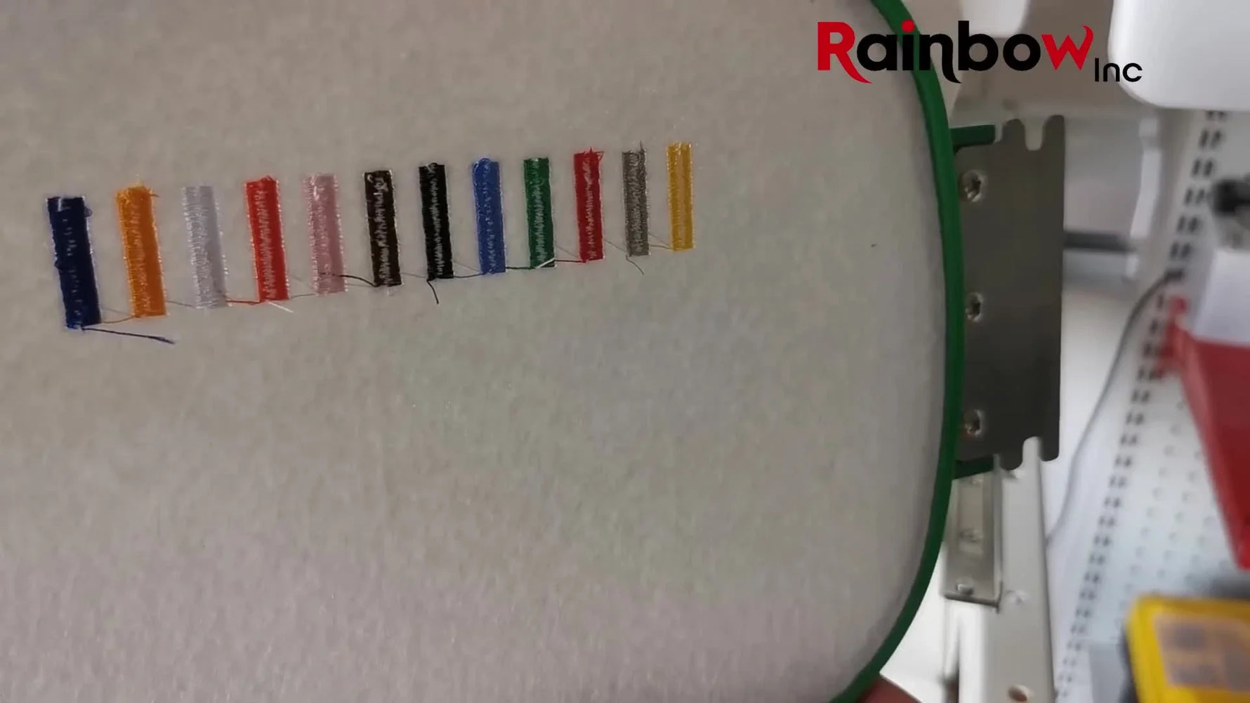 Close-up of the back of a hooped tension test strip where the 1/3 bobbin rule can be judged across multiple needle colors.