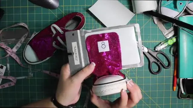 A Converse sneaker tongue is mounted sideways on a frame to show the clearance needed to stitch safely on a multi-needle embroidery machine.