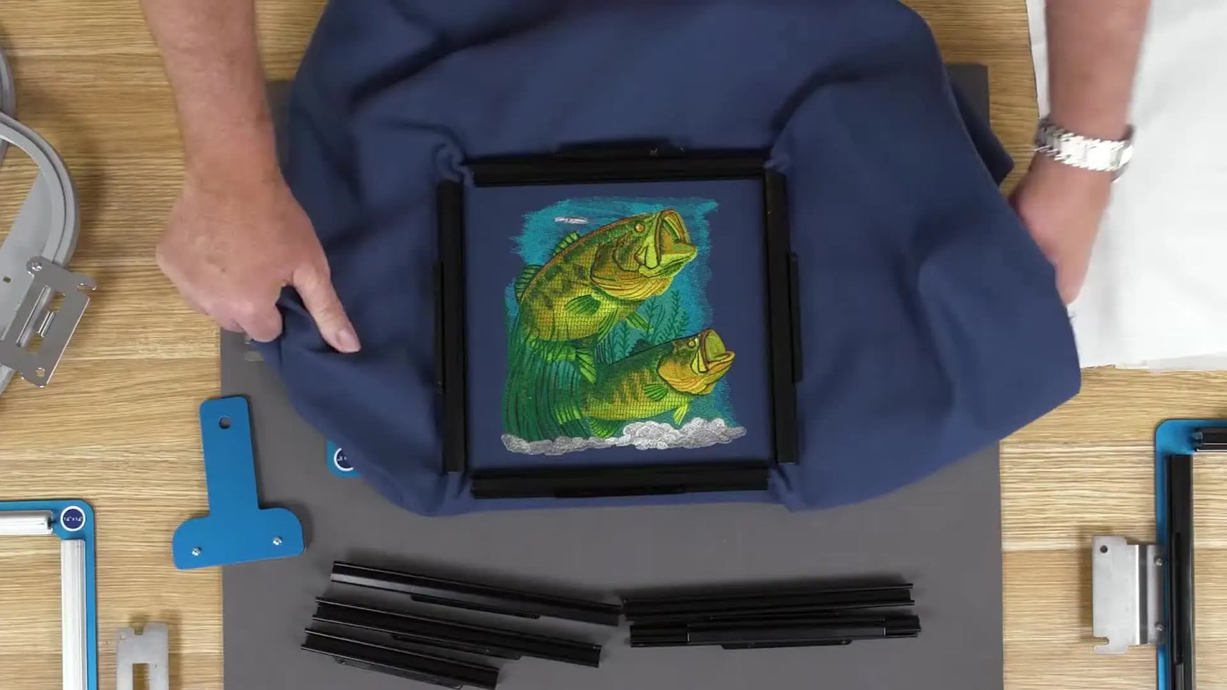 A dense embroidery design stitched perfectly flat inside a 200×200 sash frame, showing the no-pucker result that clamp-style frames are known for.