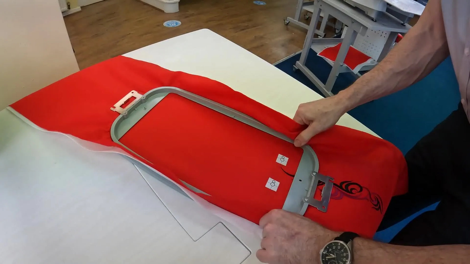 A deliberately skewed hooping setup on the Brother PR1055X demonstrates how the camera alignment compensates for crooked fabric placement.