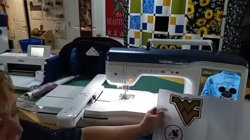 The host holds a finished sheet of embroidered patches (a WV logo and a Minnie character) beside the Brother XJ1, previewing the two outline styles.