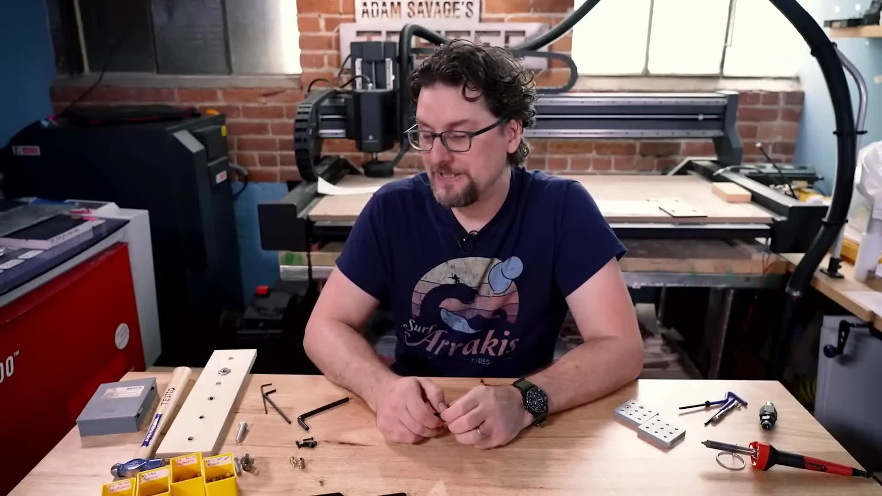 Man holding a small threaded insert.