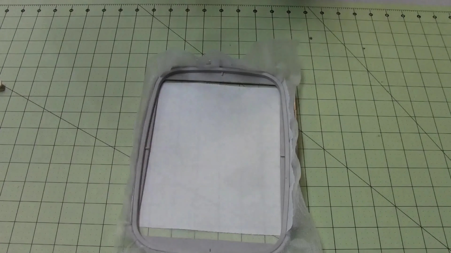 A bulky toddler shirt is clipped back with clothespins while mounted on a Brother PE770, showing how excess fabric can interfere with hoop movement.