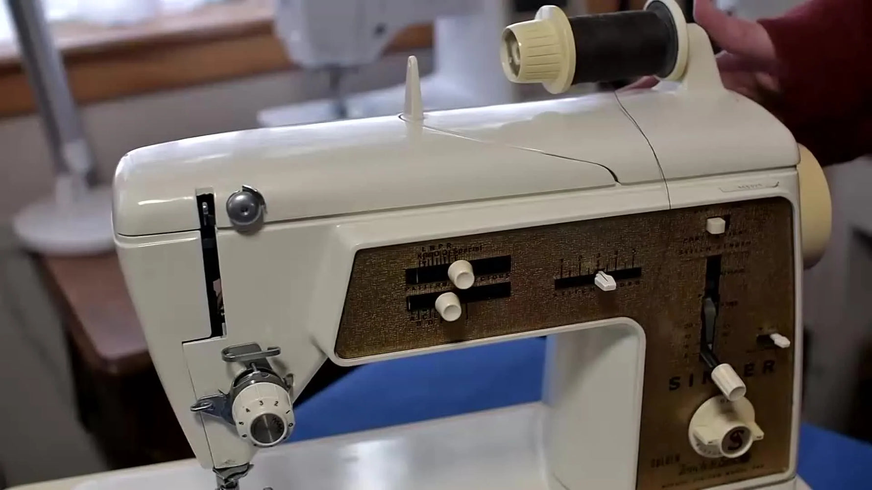 Singer Touch & Sew Golden Model 640 sewing machine with thread spool visible