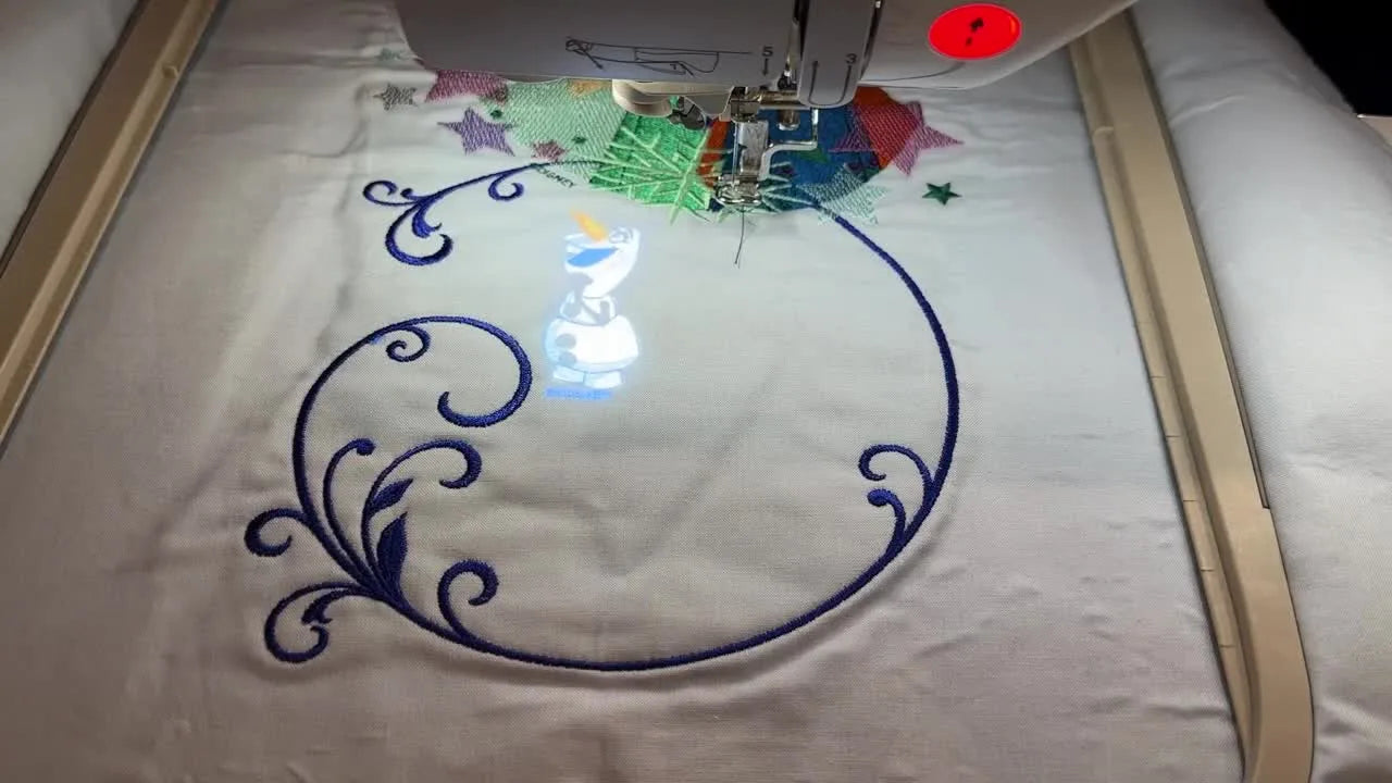 The Brother Luminaire XP3 projects a bright Olaf image directly onto hooped fabric so you can drag, rotate, and place the design precisely before stitching.