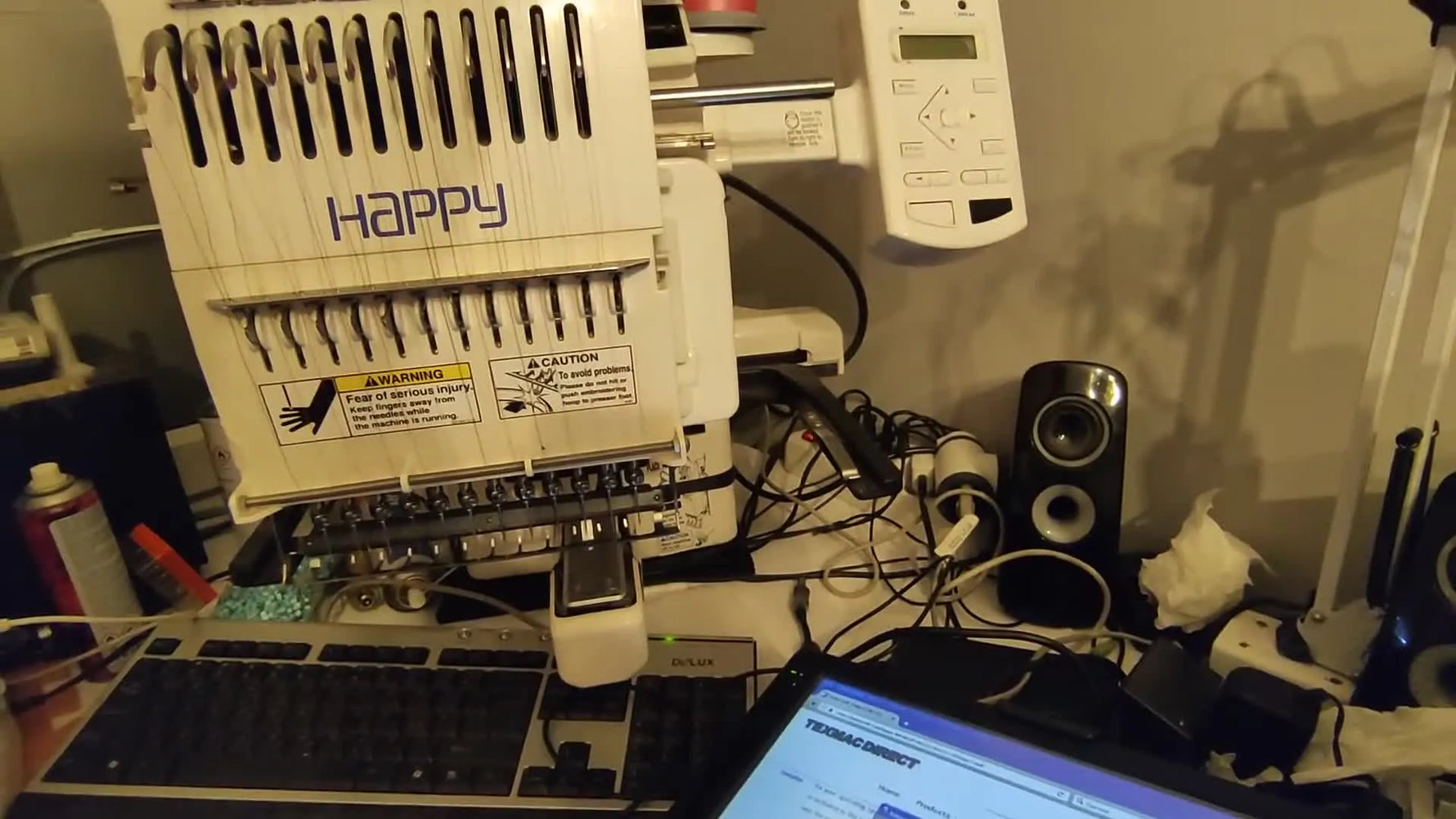 A close-up of a Happy Japan multi-needle embroidery machine head, setting the context for legacy PC-to-machine connectivity.