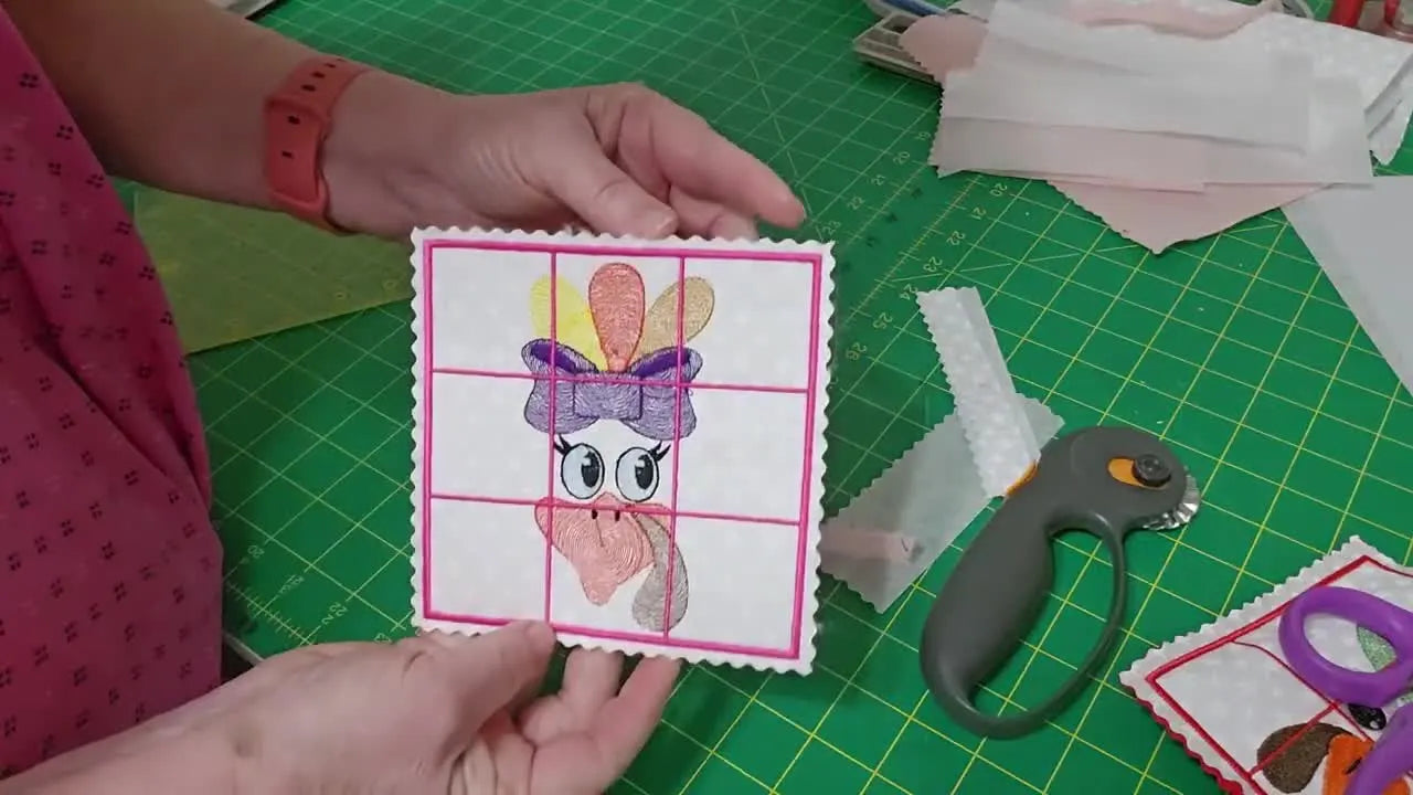 A finished in-the-hoop turkey Tic-Tac-Toe board is held up close, showing the stitched grid and decorative wavy trimmed edges.