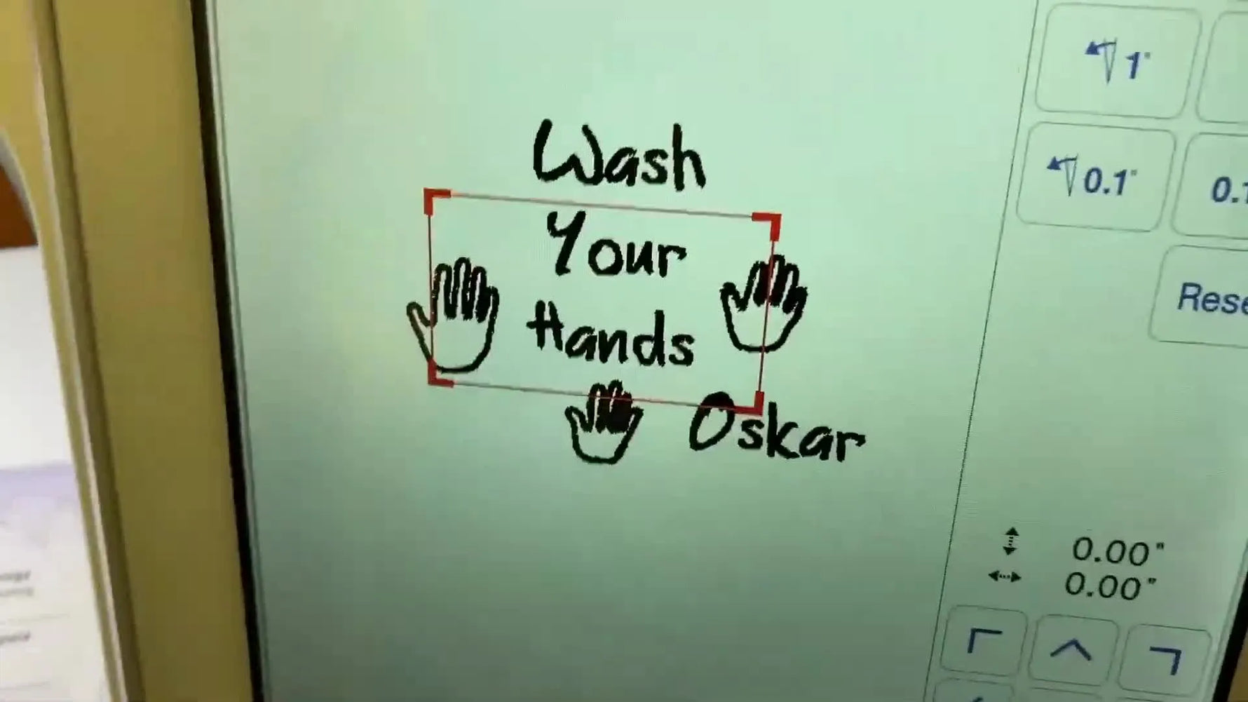 The Brother Luminaire XP1 projector displays the design directly on the hooped green towel for precise placement before stitching.