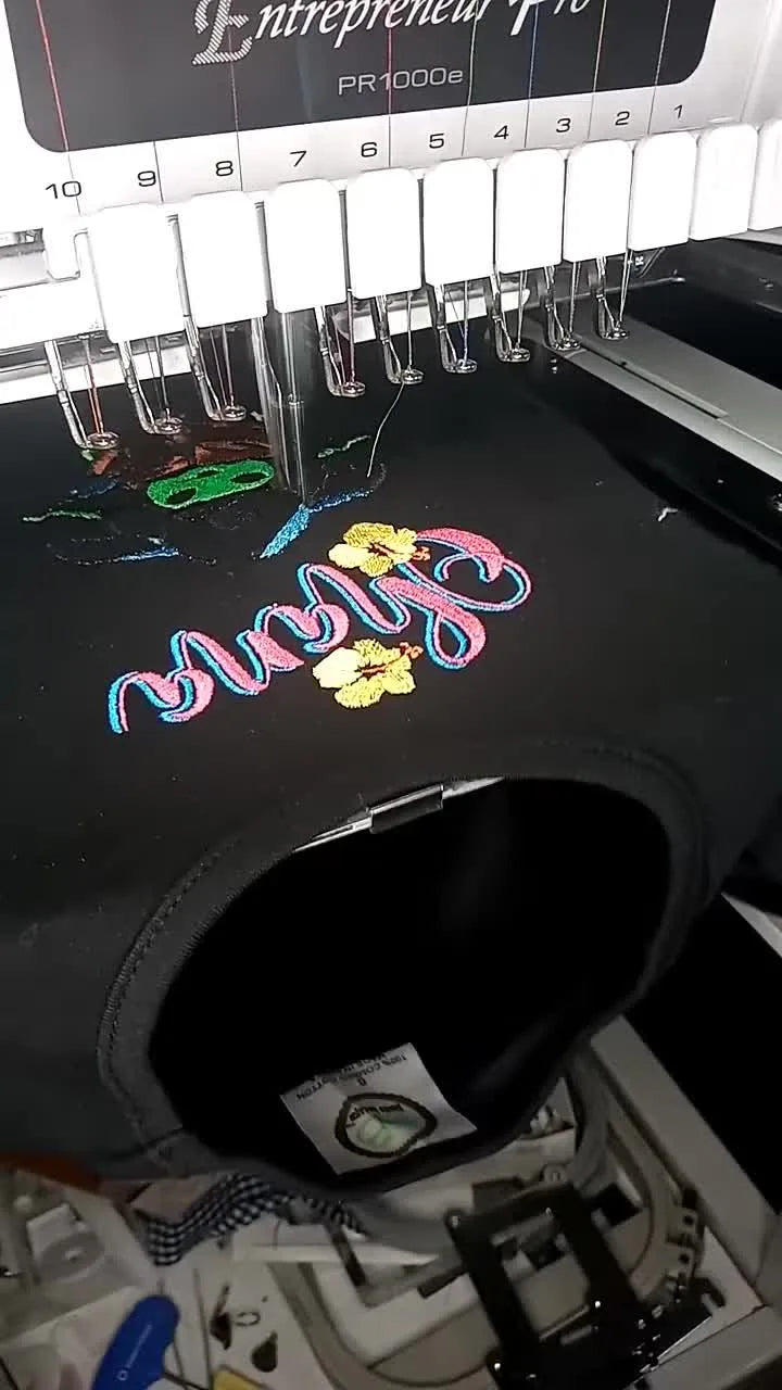 A close-up reveal of the finished black T-shirt embroidery featuring “Ohana” with Stitch and Grogu, showing clean color changes and a polished final presentation.