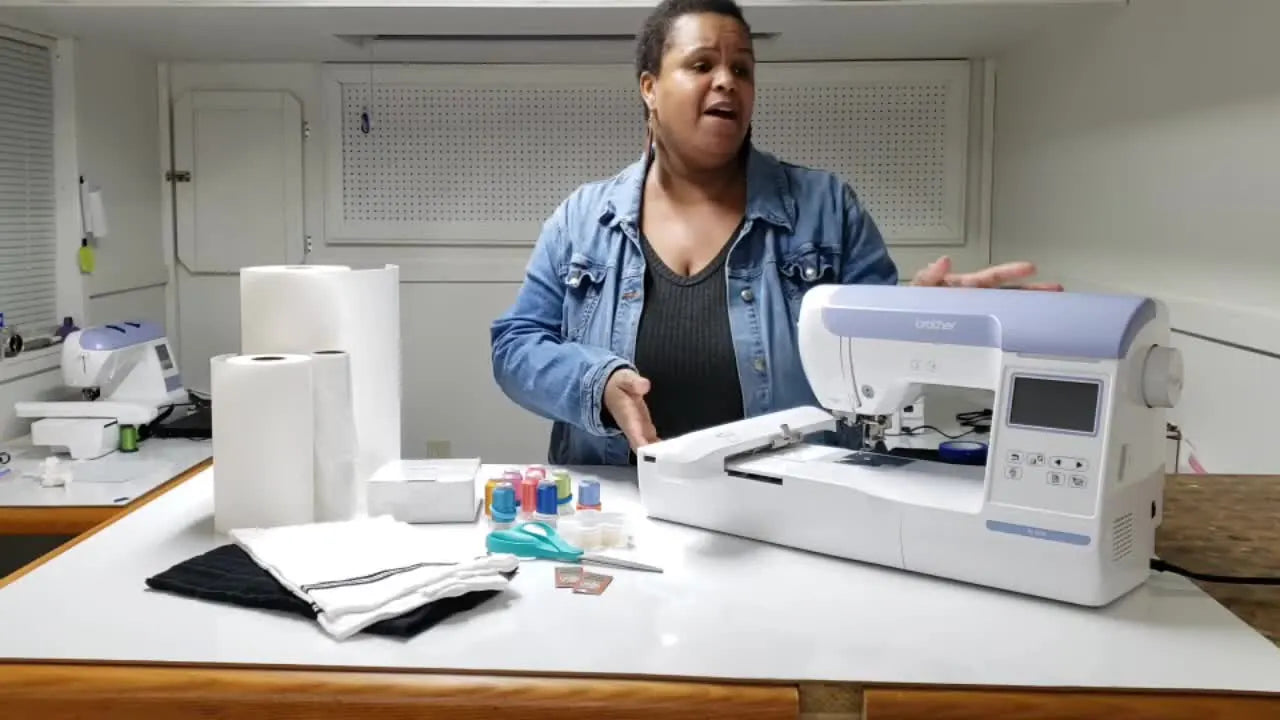 The instructor rests a hand on a Brother embroidery machine while introducing it as the foundation of a beginner supply setup.