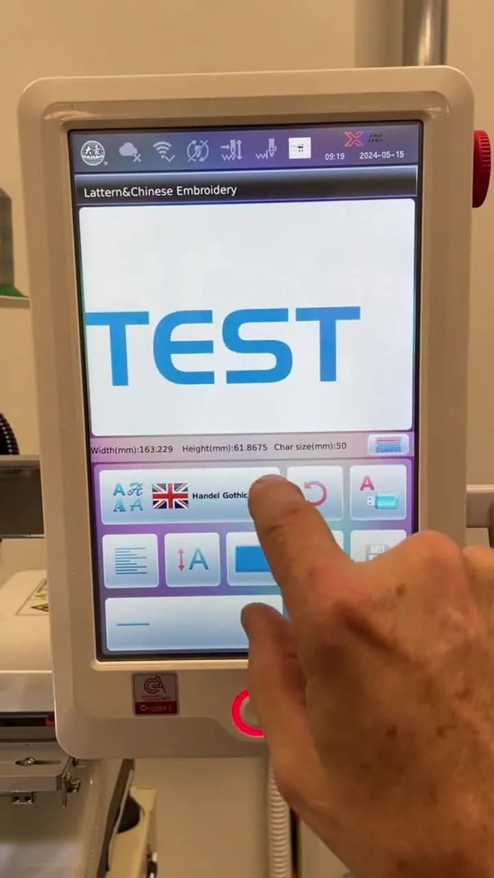 A close-up of the XT Pro touchscreen numeric keypad where the operator inputs “50” to resize built-in lettering to 50 mm.