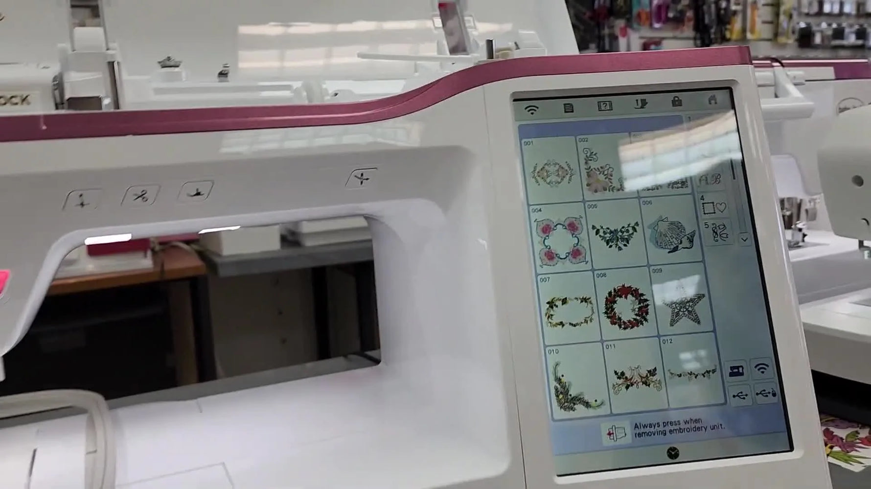 A close-up of the Baby Lock Reflection’s 10.25-inch touchscreen showing the built-in design menu.