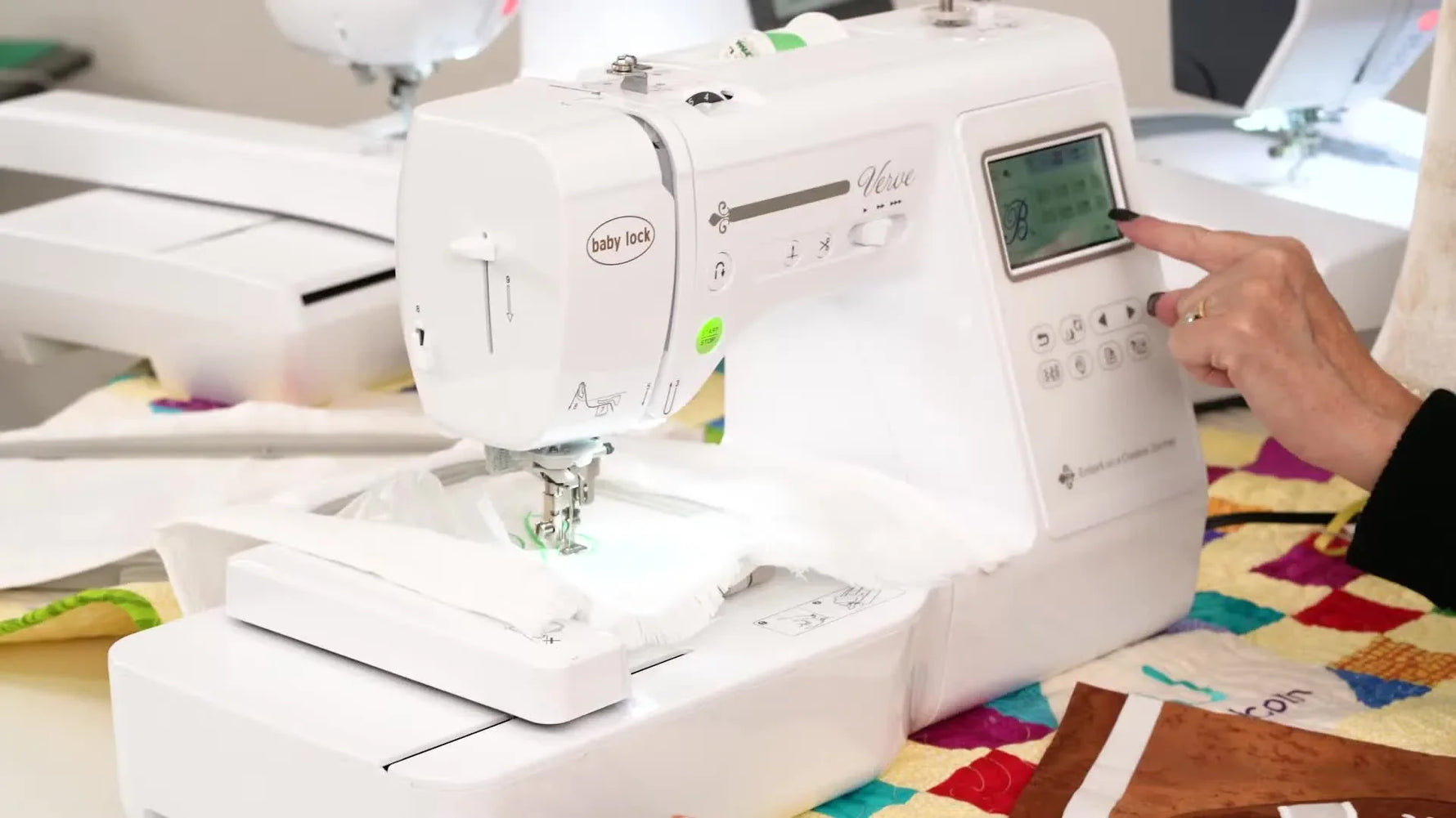 Close-up of the Baby Lock Verve screen as the green start button is pressed to finish the last stitches of a monogram.