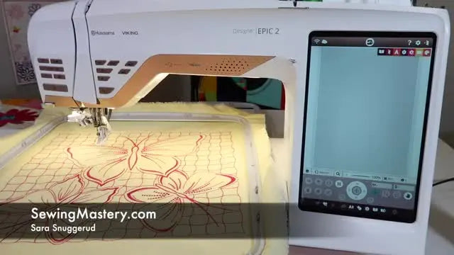 The Husqvarna Viking Designer EPIC 2 is shown with the 360x350 Majestic Hoop attached while a large split-field design is displayed on the touchscreen.