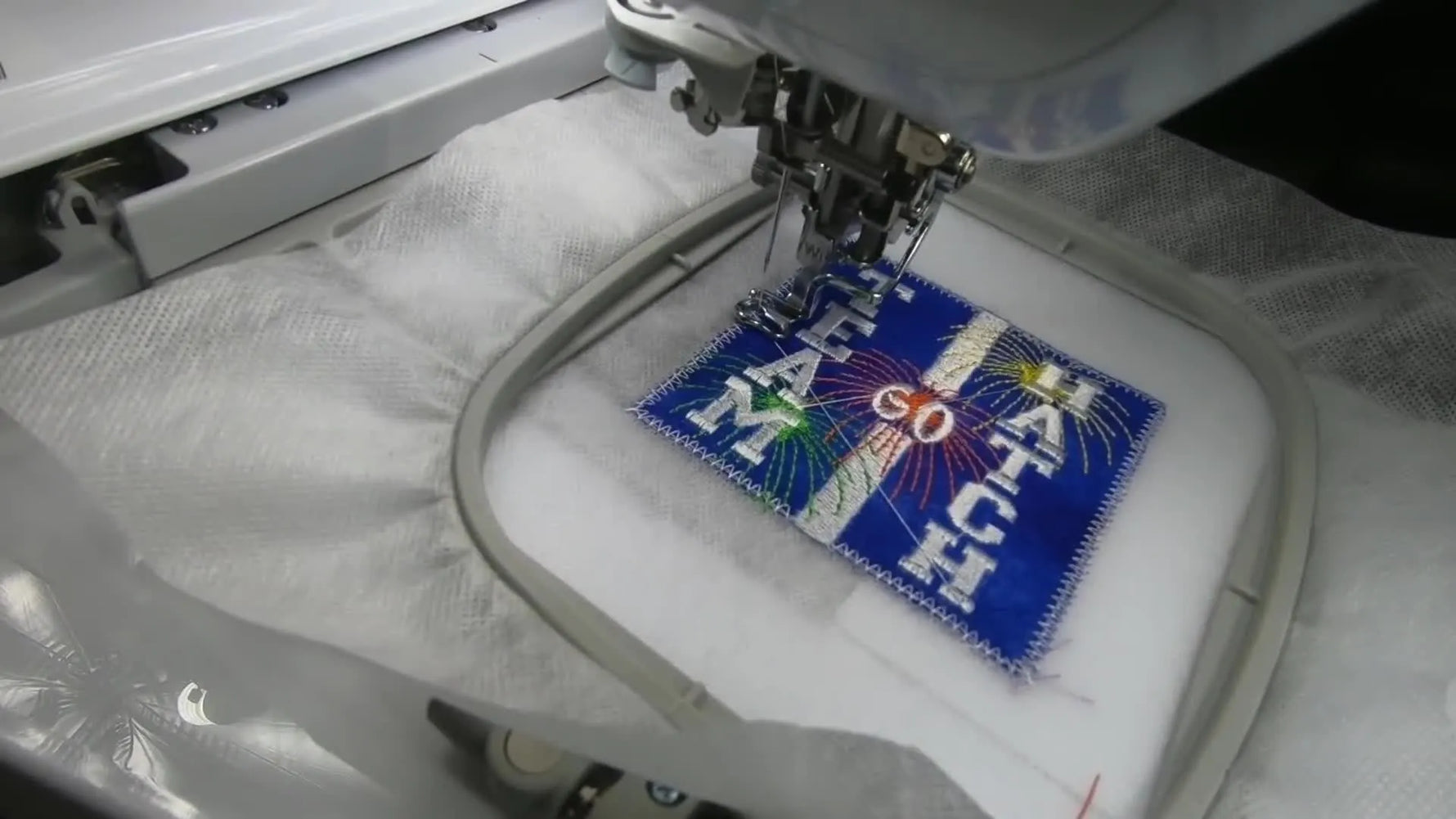 A close-up shows the Brother Dream Machine stitching a thick, dense satin border that gives the patch a professional, structured edge.