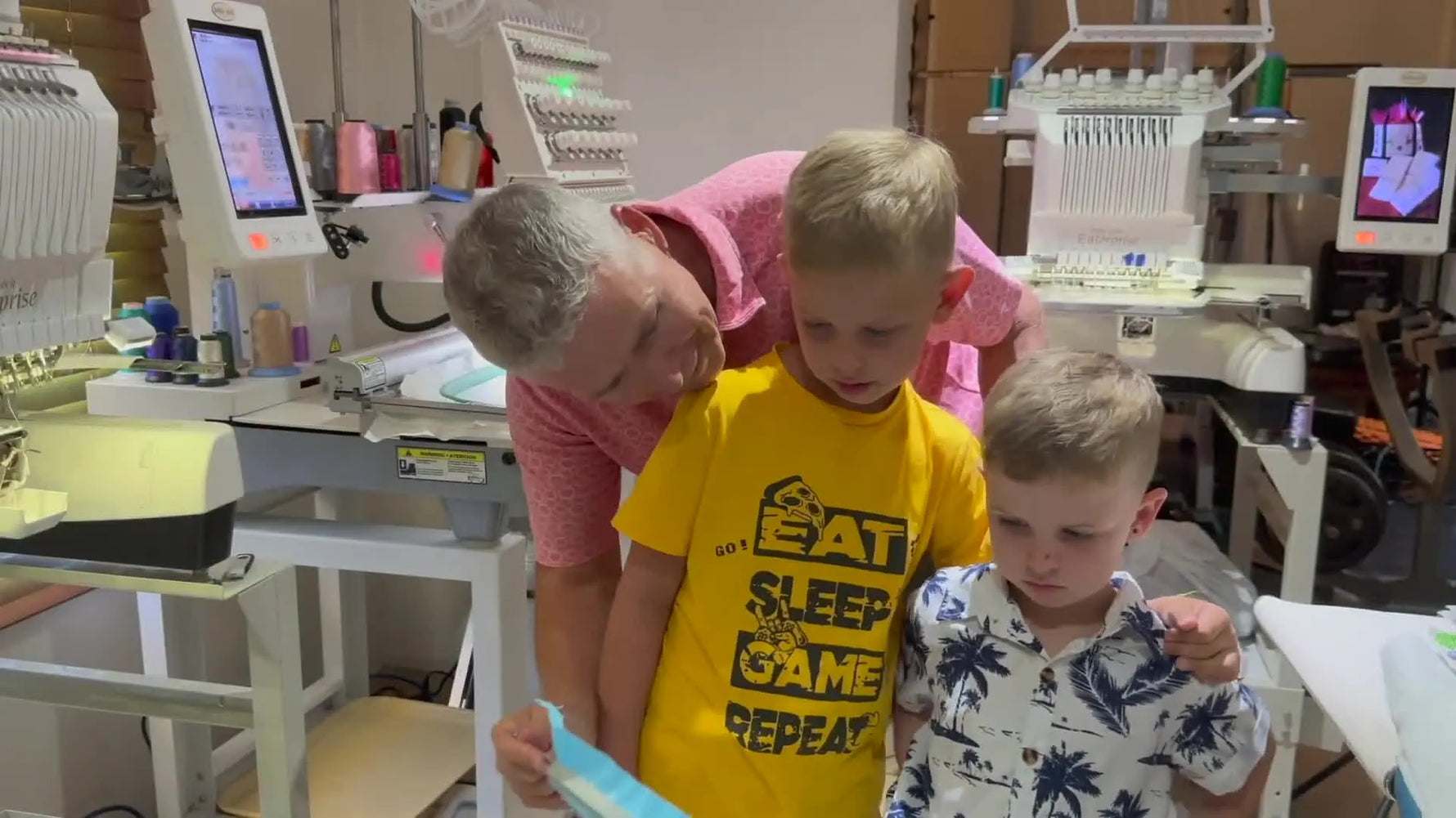 Close-up of the finished doodle-style embroidery stitched on blue knit fabric while still held taut in the hoop.