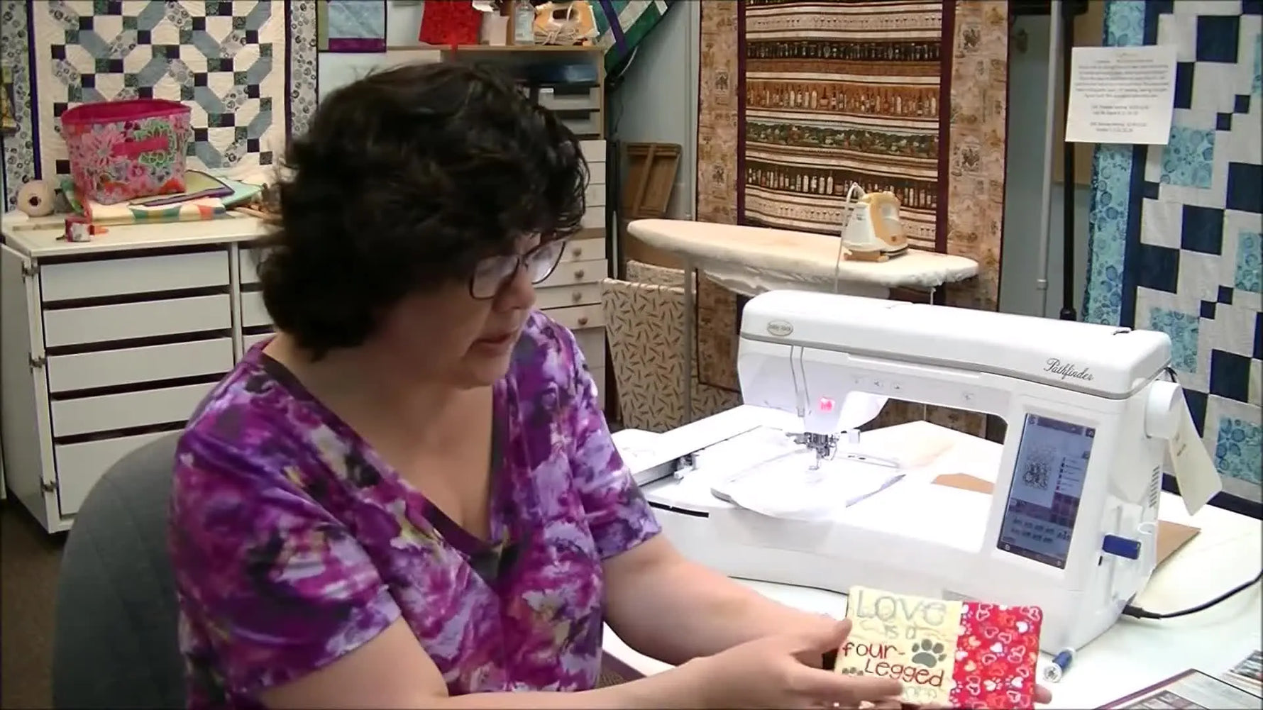 A close-up of a finished in-the-hoop mug rug sample held up for a clear look at the quilting texture and clean edges.