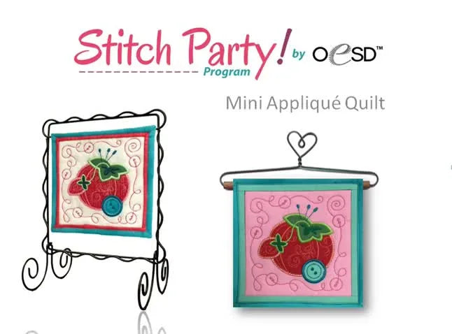 A close-up of the finished 6-inch mini tomato appliqué quilt displayed on a wire stand, showing crisp satin edges and decorative quilting.