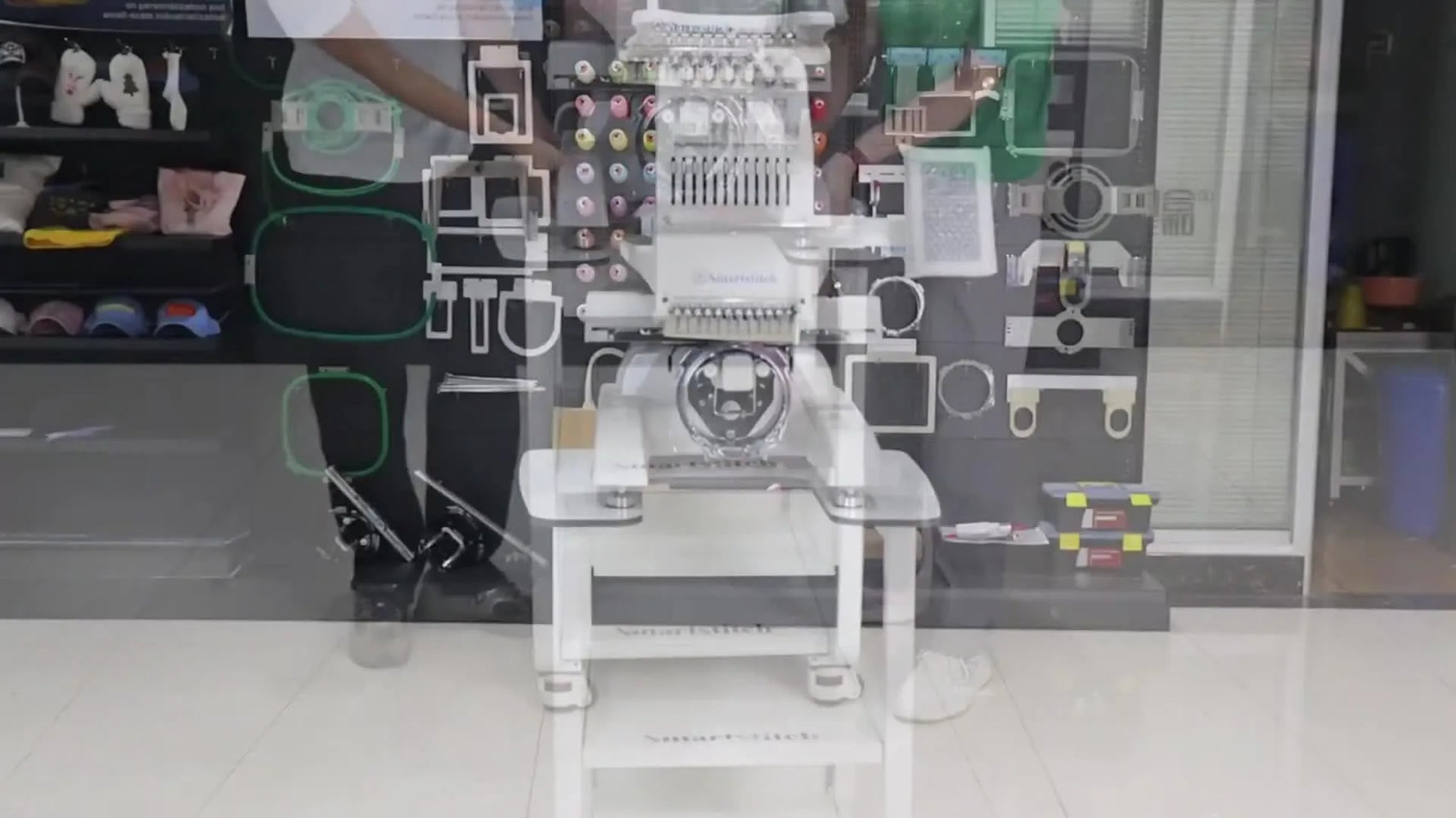 A fully assembled Smartstitch multi-needle embroidery machine sits centered on its finished heavy-duty stand, ready for stable production.