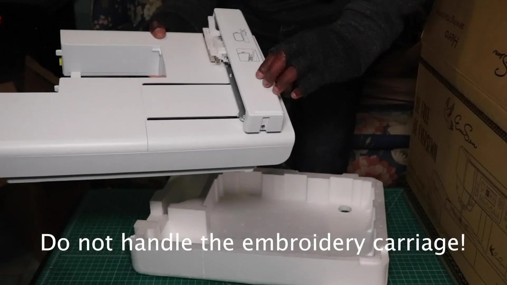 The EverSewn Hero combination machine is shown front-on on a cutting mat right after being removed from the box.