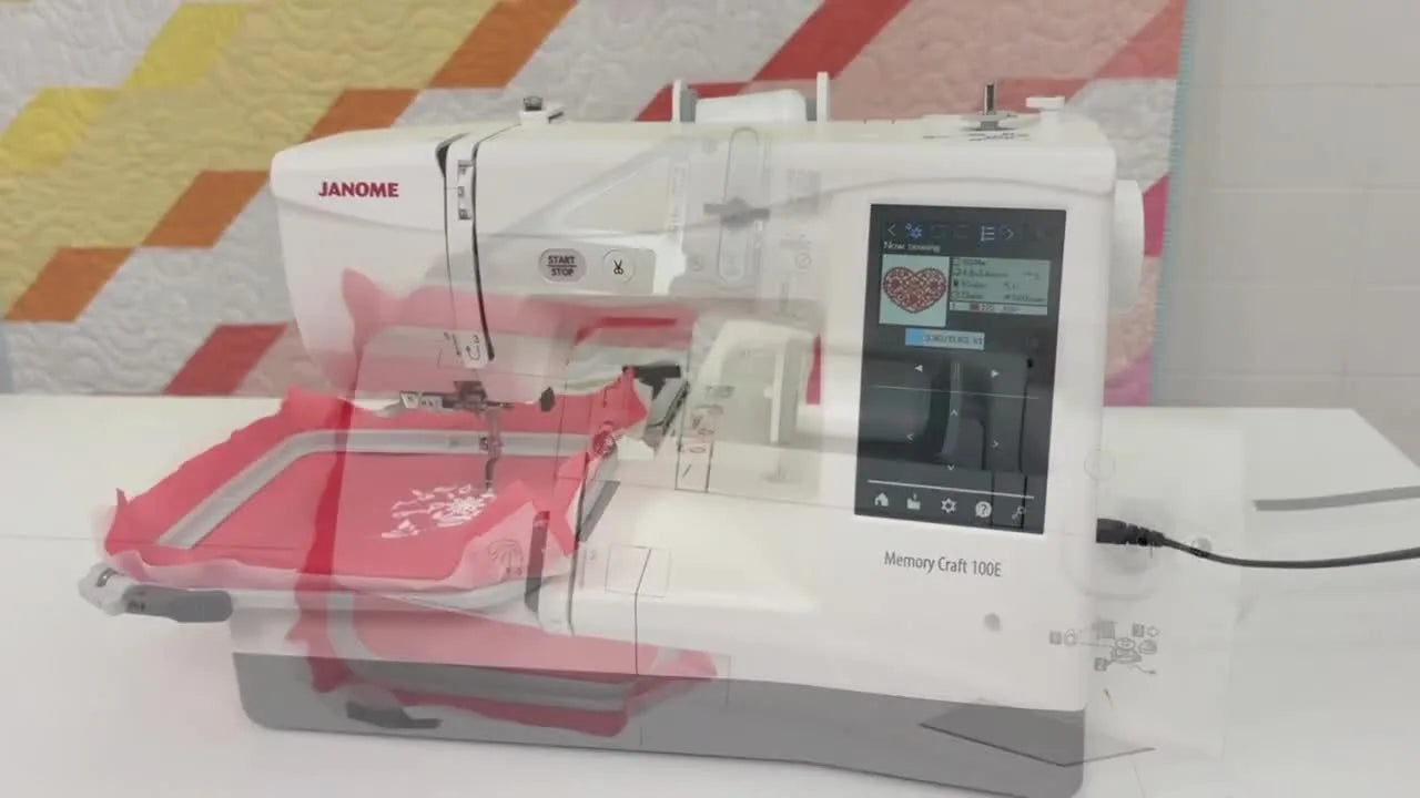 An overhead view of the Janome Memory Craft 100E showing the free arm area with a hoop attached for tubular garment embroidery.