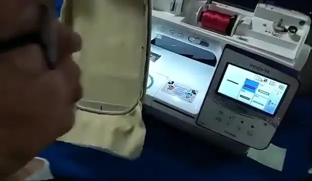 A close-up shows the hooped fabric sliding into the Brother Innov-is NQ3600D embroidery arm until it clicks into place.