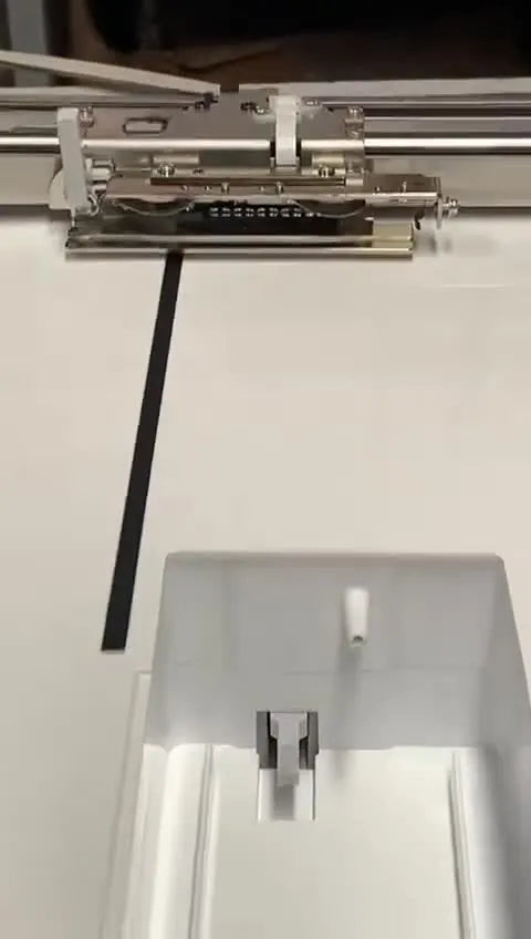 Close-up of pliers gently compressing the Brother embroidery unit’s butterfly spring to reduce hoop insertion friction.