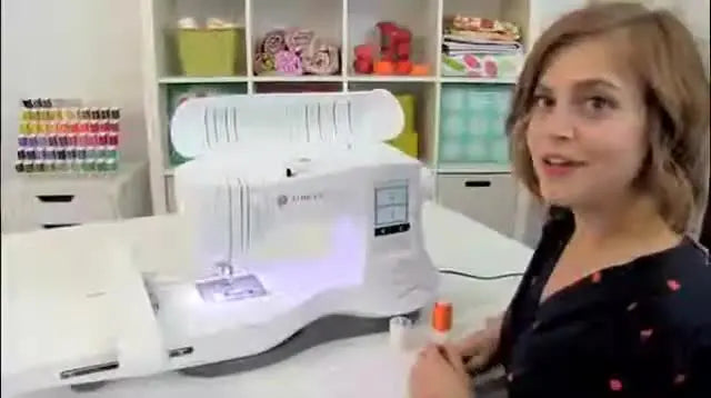 A clear, well-lit view of the SINGER Legacy machine on a white workspace as the presenter begins the threading setup.