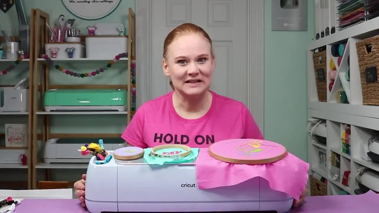 Overhead shot of Cricut machine, washable pen, fabric, embroidery hoops, thread, and FabricGrip mat.