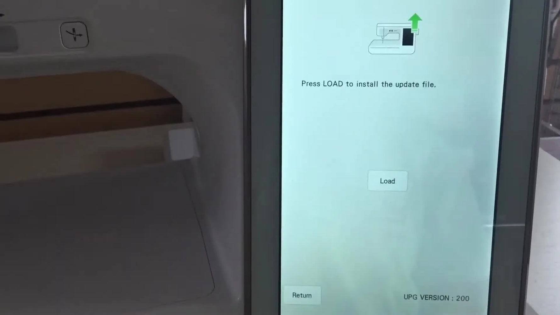 The Baby Lock Solaris update-mode screen shows the Wi‑Fi icon and the central Load button used to flash Firmware 2.01.