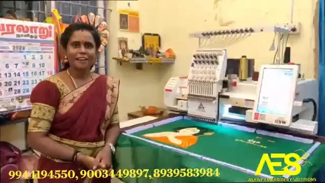 A shop owner stands beside her HSW single-head multi-needle embroidery machine with fabric mounted, showing a real small-business workspace setup.