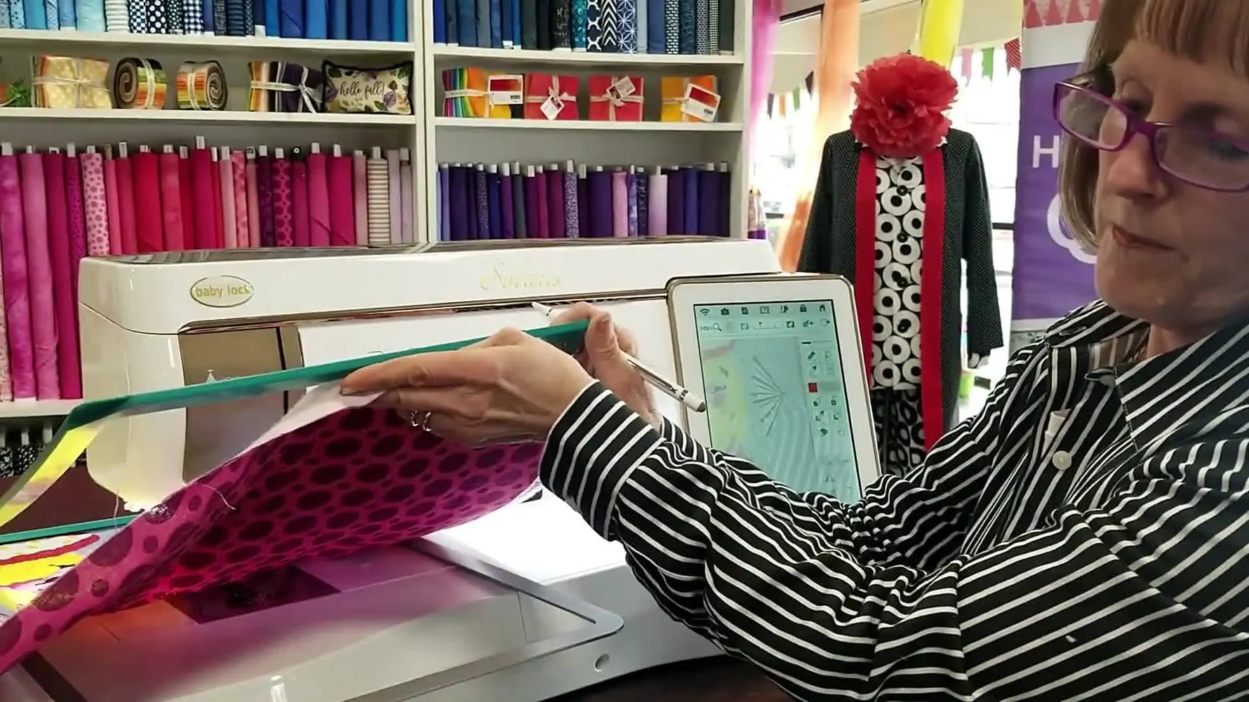 Kimberly demonstrates snapping a strong magnetic hoop onto a three-layer quilt sandwich on the Baby Lock Solaris for quick re-hooping during quilting.