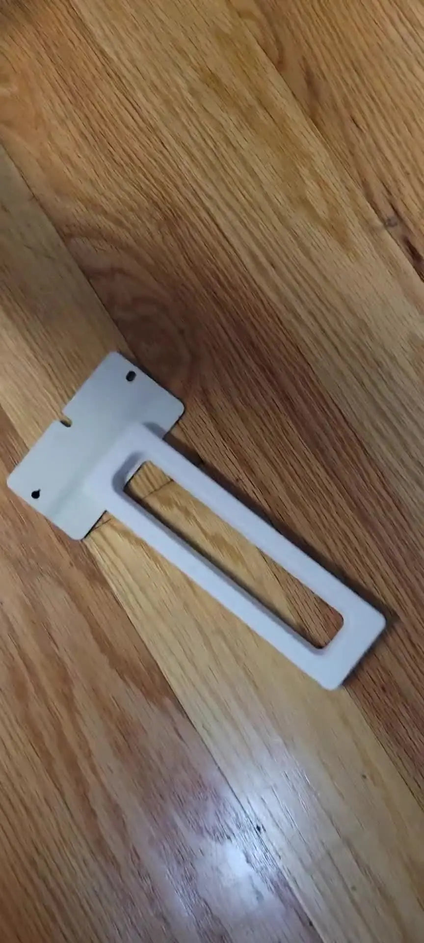 A red snapback cap is secured to a metal Fast Frame with sticky backing, ready for stable embroidery.