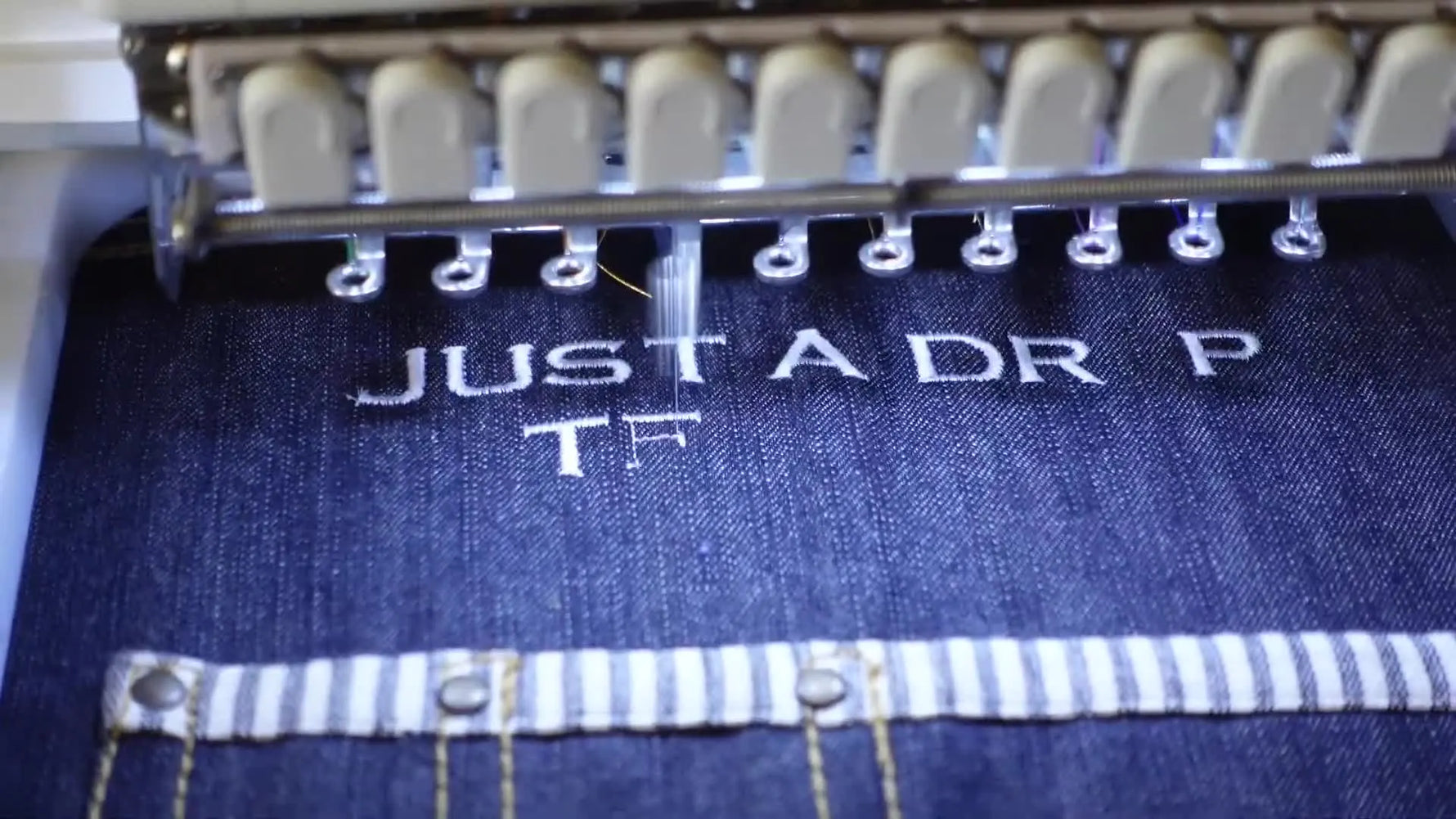 Final apron held up, showing crisp text and blue water drop.