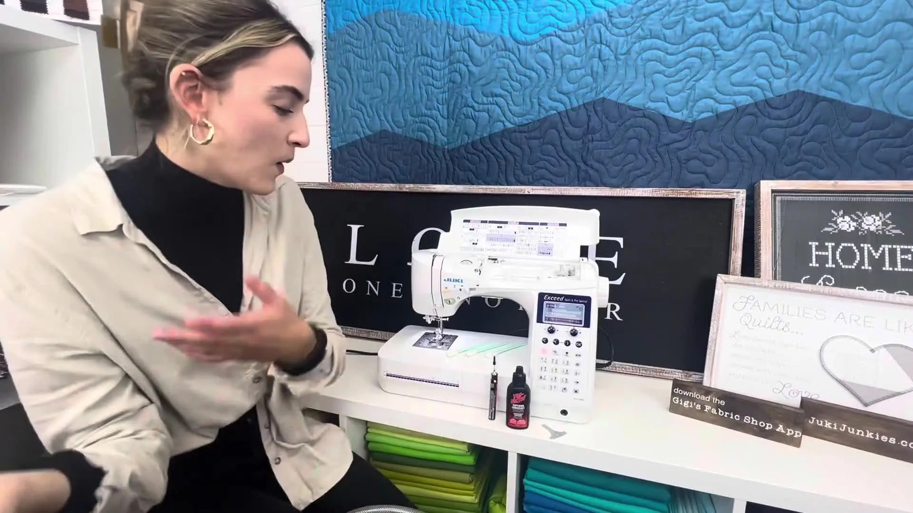 Woman standing next to a Juki sewing machine with its top open, showcasing cleaning tools on the table.