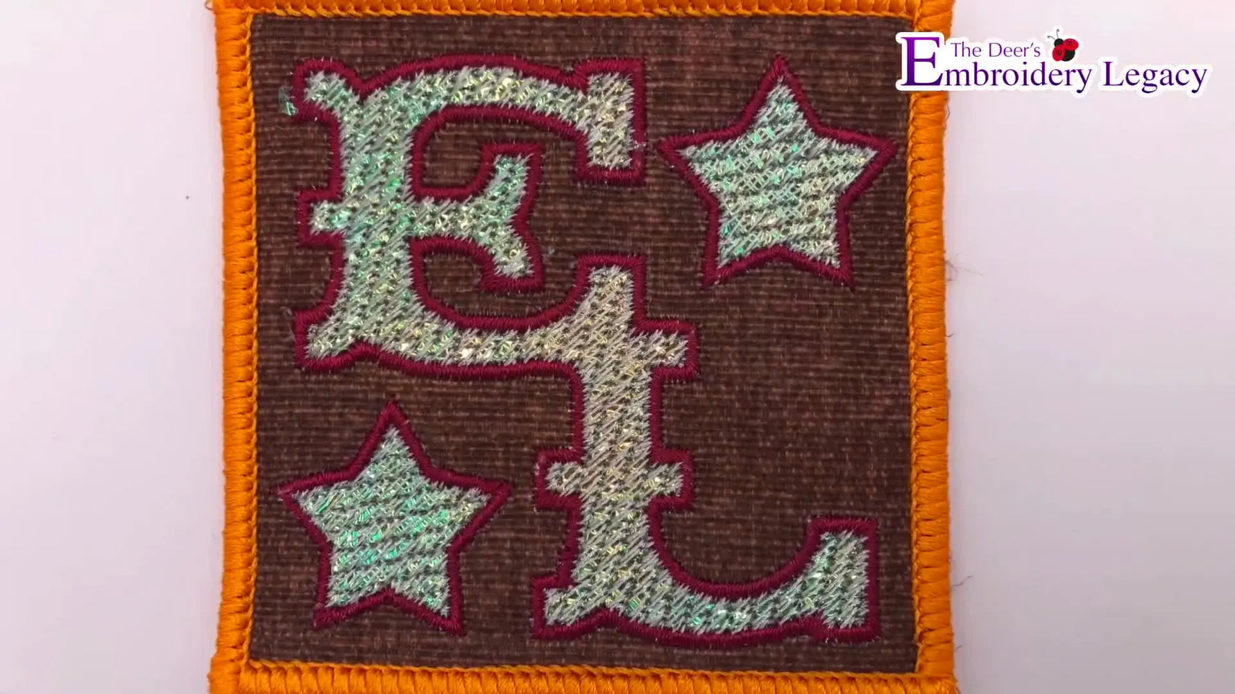 A close-up of the finished “EL” patch showing the reflective Mylar sparkle effect under the stitches.