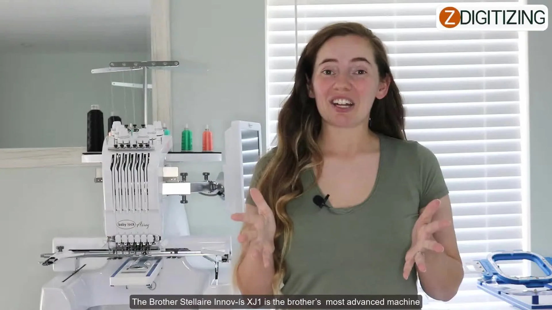 A wide studio view of the Brother Stellaire Innov-is XJ1 with an embroidery design displayed on its large screen.