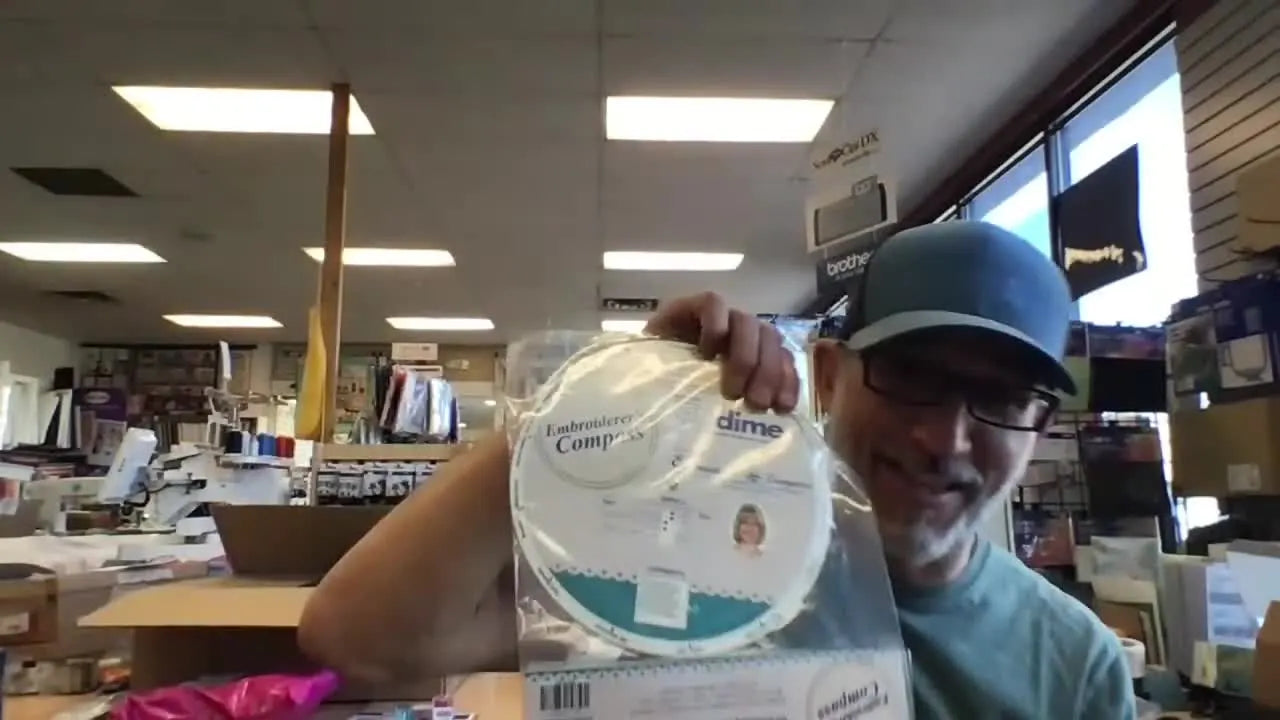 A close-up of Patrick holding an embroidery positioning tool during a live Q&A about machine troubleshooting and hoop maintenance.