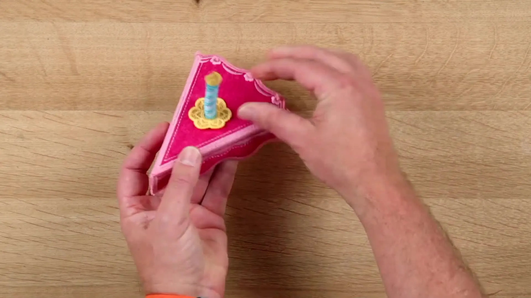 The finished freestanding cake box is opened to show the storage space inside the stitched 3D slice.