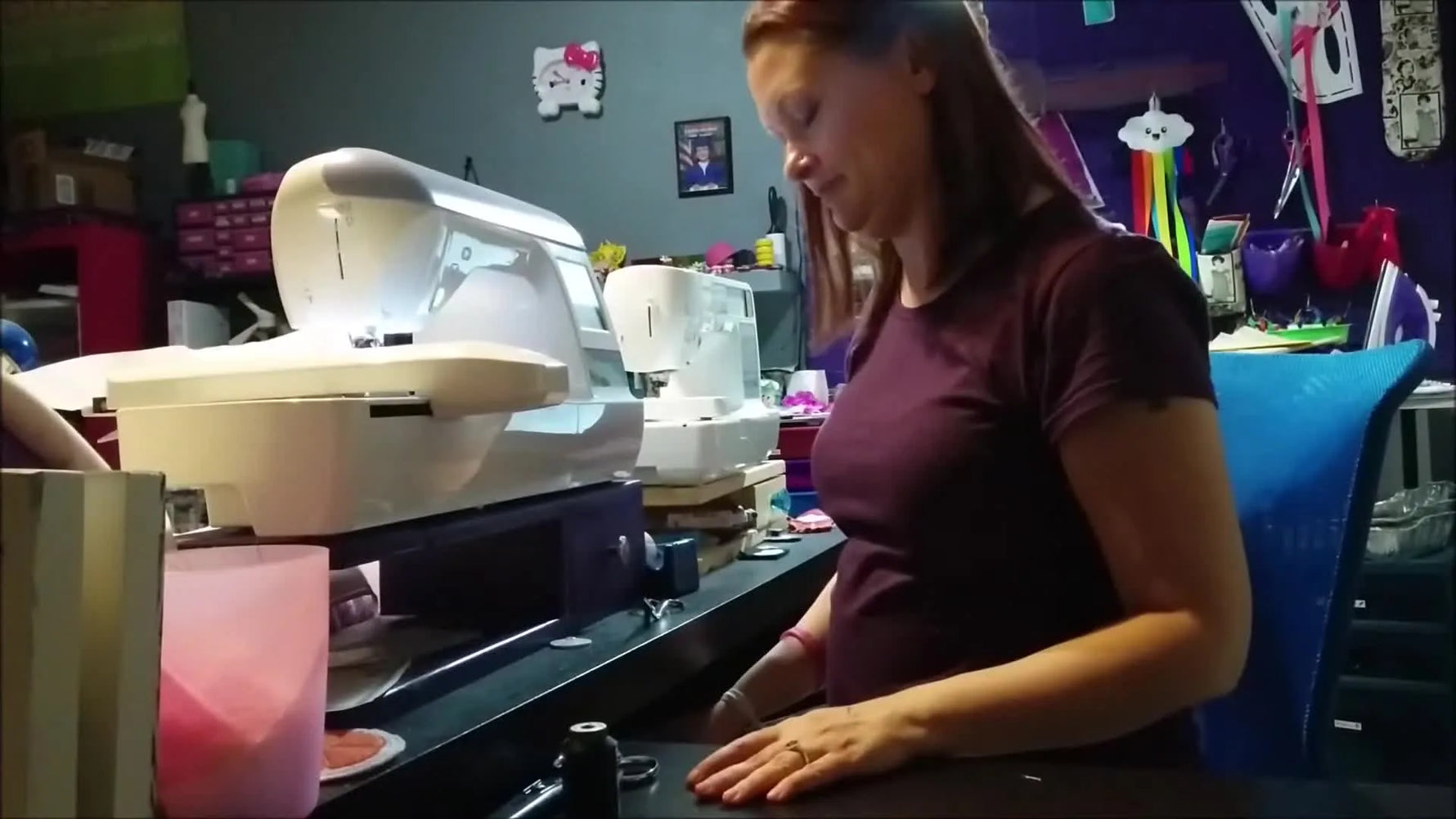 An extreme close-up of the embroidery machine stitching the whale puzzle outlines through layered felt in the hoop.