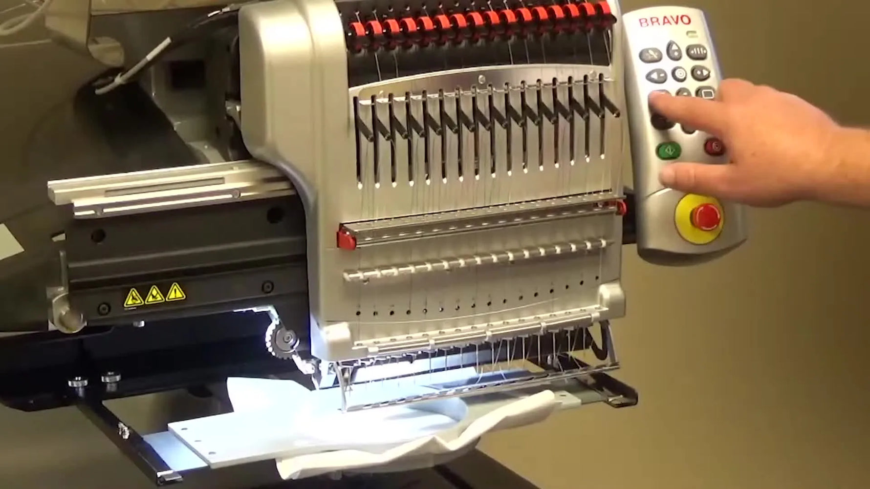 Close-up of two fingers pressing the Melco Bravo keypad buttons “Adjust” and “Frame” together to clear a trim-related stop.