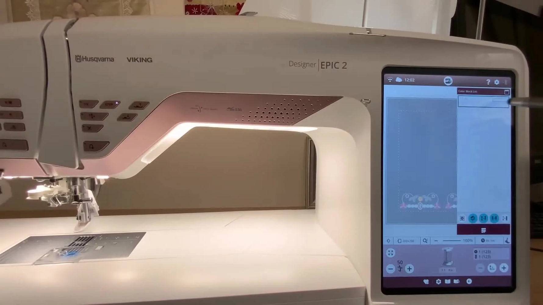 A finished floral corner border stitched in a 200x200 hoop on delicate fabric, shown from an overhead view for join accuracy.