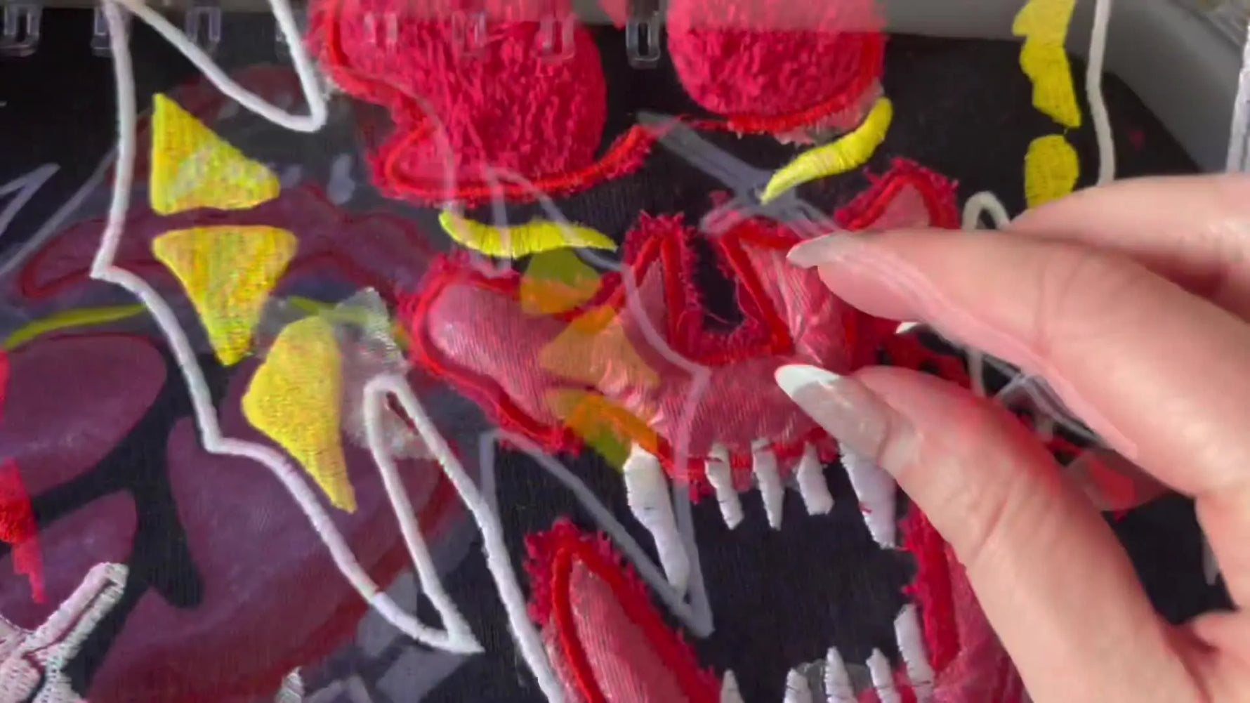 The finished Hellfire Club hoodie is shown being worn, highlighting the bold faux chenille towel appliqué and clean satin borders.