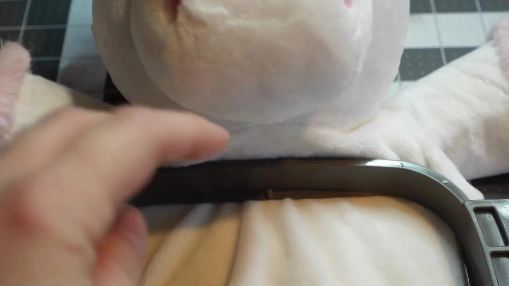 Close-up showing the hoop's center marking aligned with the unicorn's face.