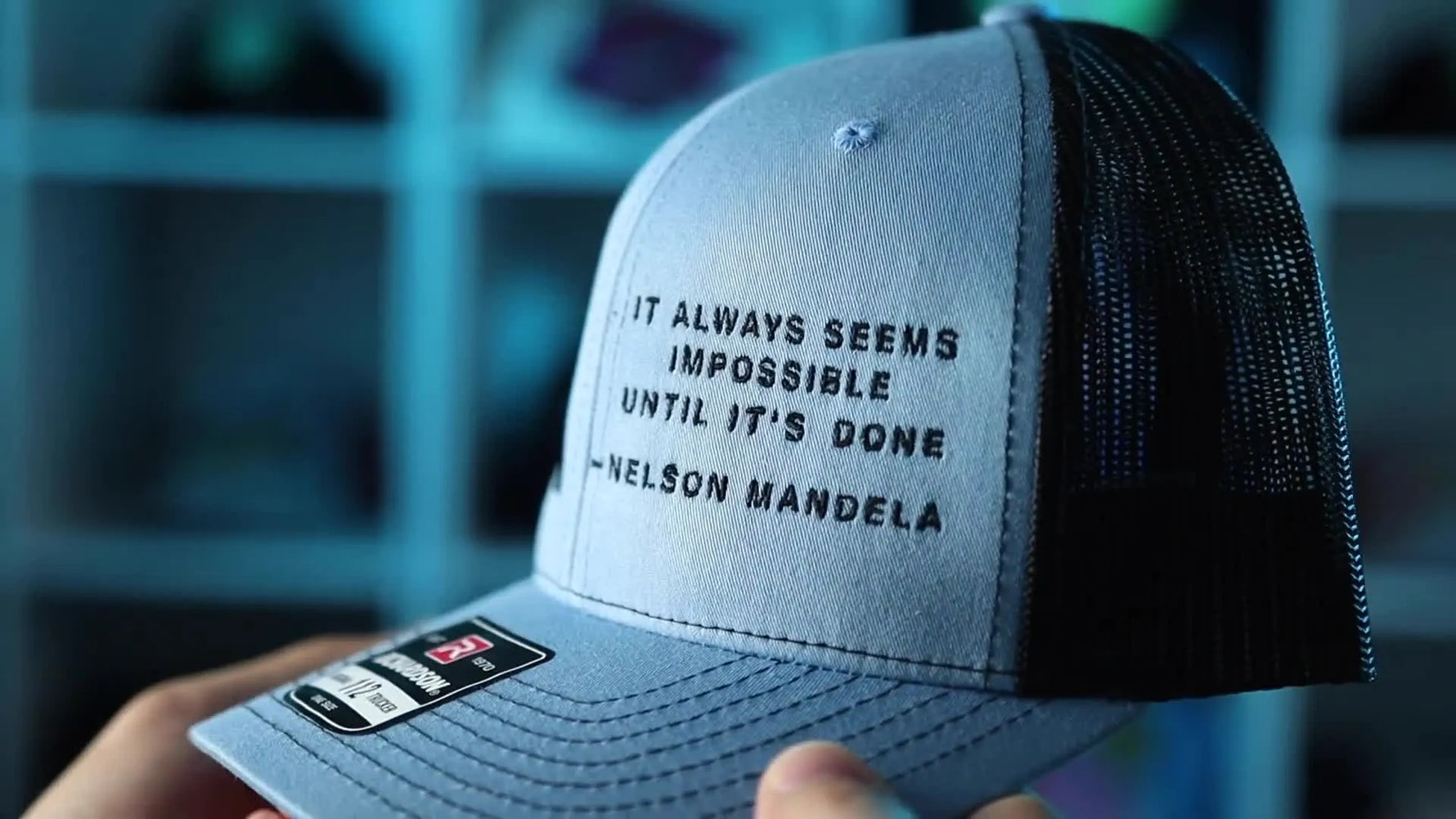 A close-up of a finished Richardson 112 cap showing crisp, readable small black lettering on the structured front panel.