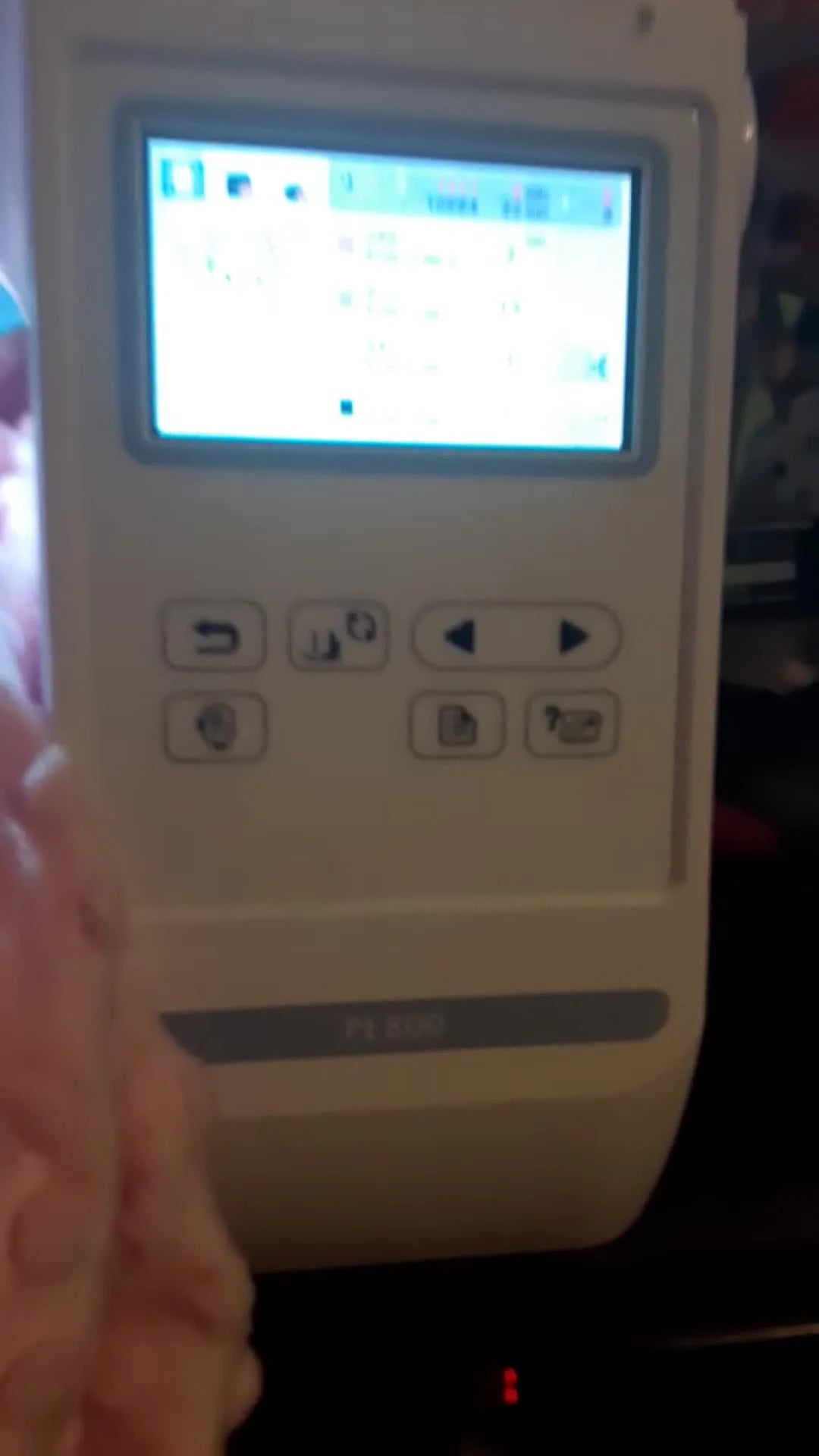 The Brother PE800 LCD displays the elephant design preview with stitch count and color stops before stitching begins.