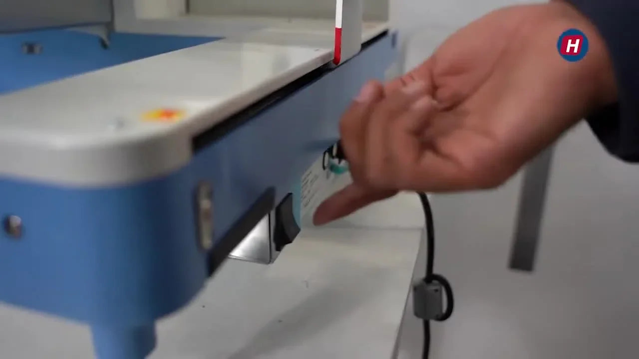 A close-up of the operator holding the blue Start button while the HappyJapan HCD3-1501 boots into Maintenance Mode.