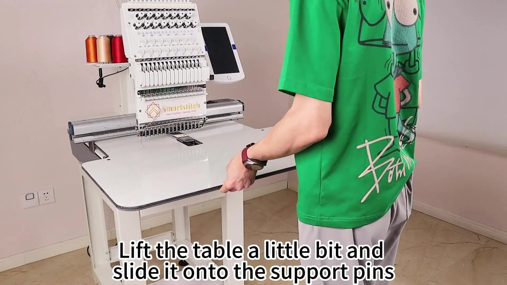 A close-up view of the Smartstitch extension table sliding cleanly onto the support pins with the sewing arm centered in the table opening.